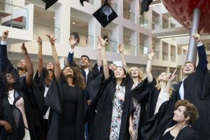 University students throwing their caps in the air on graduation day